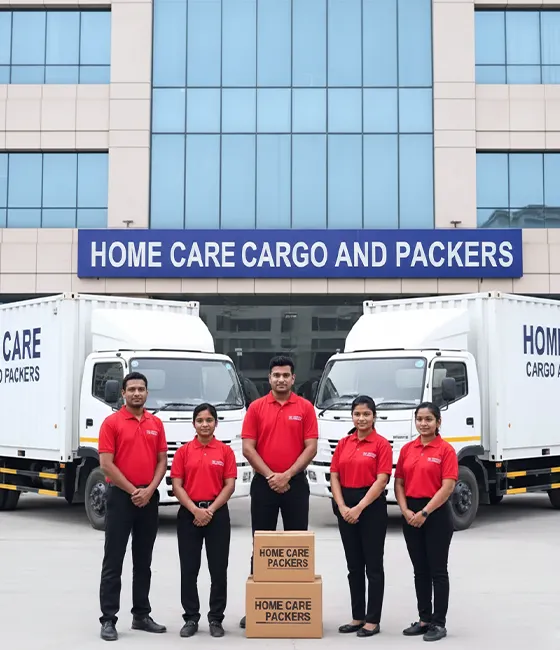 Home Care Cargo Packers team in Gurugram with branded trucks and packed boxes.