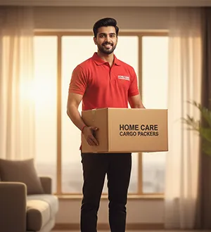 Home Care Cargo Packers team member holding a packed box in a bright Gurugram home.
