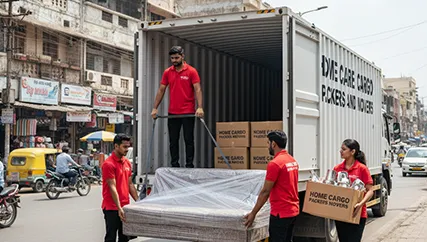 Movers unloading household goods in Ahmedabad during a relocation along Rajkot Highway