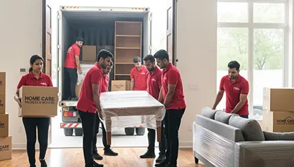 Unloading furniture during household relocation in Ambawadi