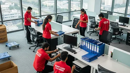 Office movers unpacking desks, computers, and office equipment in Ashram Road
