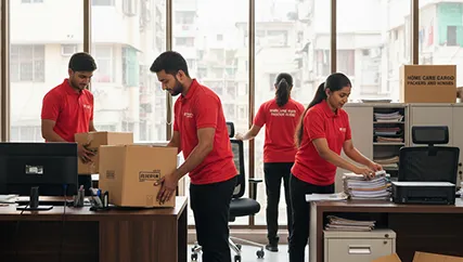 Office movers unpacking office desks, computers, and chairs in Chanakyapuri, Ahmedabad