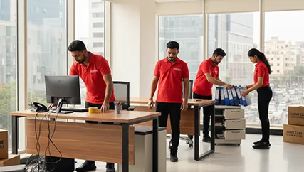 Movers unpacking office furniture and setting up computers in D Colony, Ahmedabad