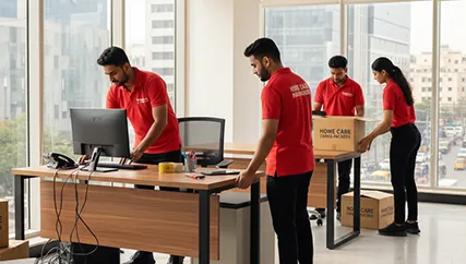 Office movers unpacking desks, computers, and setting up office equipment in Dariapur, Ahmedabad
