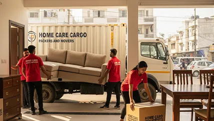Movers unloading furniture and fragile boxes during a household relocation in Dhalka, Ahmedabad