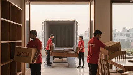 Movers unloading large furniture and boxes during household relocation in Dholera, Ahmedabad