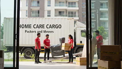Movers unloading household boxes from the truck into the new home