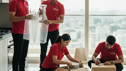 Movers Packing Household Items with Care