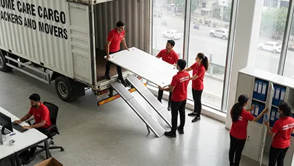 Office Relocation – Movers Placing Office Furniture