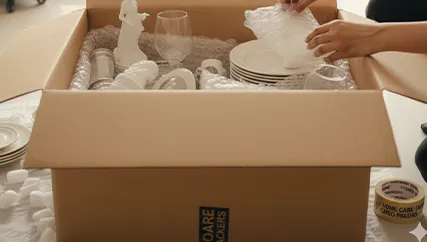 Delicate items wrapped in bubble wrap and packed into a secure moving box