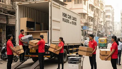 Movers unloading furniture and electronics during an office relocation in Ashok Vihar Phase 3