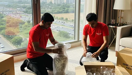 Movers wrapping fragile items for relocation in Gurgaon Faridabad Road, Gurugram