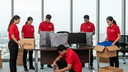 Office movers disassembling office furniture and packing electronics in Sector 101