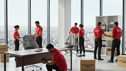Office movers carefully disassembling office furniture and packing electronics in Sector 111