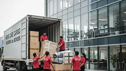 Movers unloading office furniture in Sector 16, Gurugram