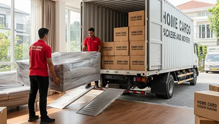 Movers loading furniture into truck in home relocation