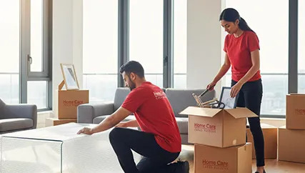 Professional movers packing and arranging household items for a safe move
