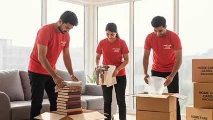 Experienced movers packing household items in boxes for a secure move