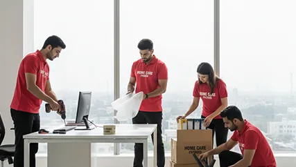 Movers handling office furniture and electronics with care during office relocation