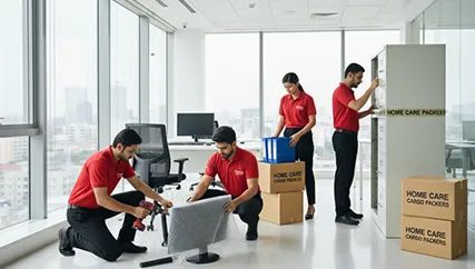Movers disassembling office furniture for relocation