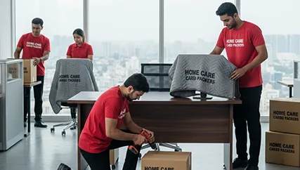 Office movers disassembling office furniture and packing office electronics in Sector 80