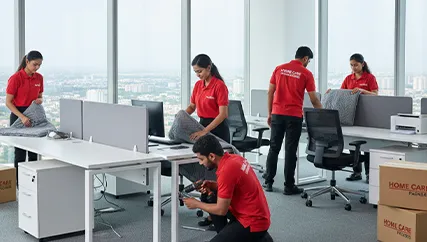 Office movers disassembling office furniture and packing electronics in Sector 82