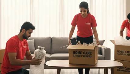 Movers wrapping fragile items carefully and preparing them for transport