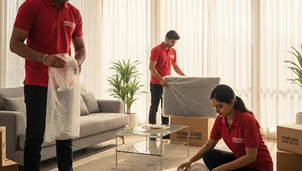 Movers wrapping fragile items like glassware and electronics with care in Sector M 10