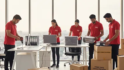 Office movers disassembling office furniture and packing electronics in Sector M 13