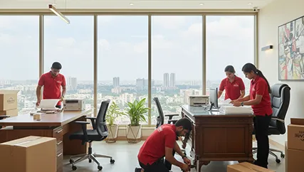 Office movers disassembling furniture and packing electronics in Sohna Sector 11, Gurugram