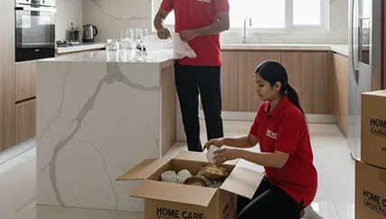Movers wrapping fragile kitchenware and decor in Sohna Sector 17, Gurugram