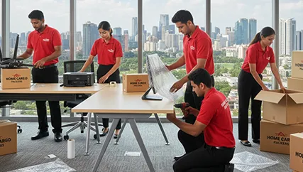 Office movers disassembling furniture and packing electronics in South City, Gurugram