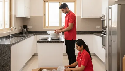 Movers wrapping kitchenware and fragile items in Sushant Lok Extension, Gurugram