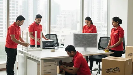 Office movers disassembling furniture and packing electronics in Sushant Lok I, Gurugram