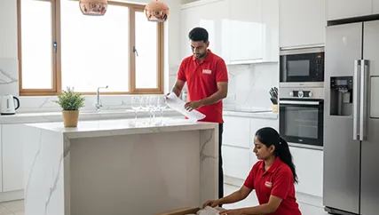 Movers wrapping fragile kitchenware in Sushant Lok Phase 2, Gurugram