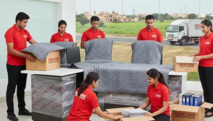 Professional movers relocating office equipment in Kanota, Jaipur with protective materials