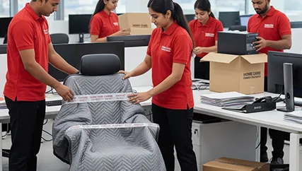 Office movers organizing and packing office chairs, computers, and other equipment