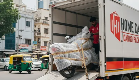Professional mover carefully loading a motorcycle onto a transport vehicle for safe relocation
