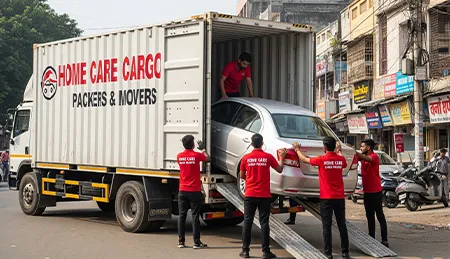 Home Care Cargo Packers team carefully loading a car onto a specialized transport truck for secure relocation.