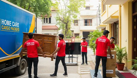 Professional movers unloading boxes and furniture into a residential home, ensuring safe placement