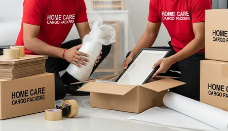 Professional movers packing household items with high-quality materials like bubble wrap and tape